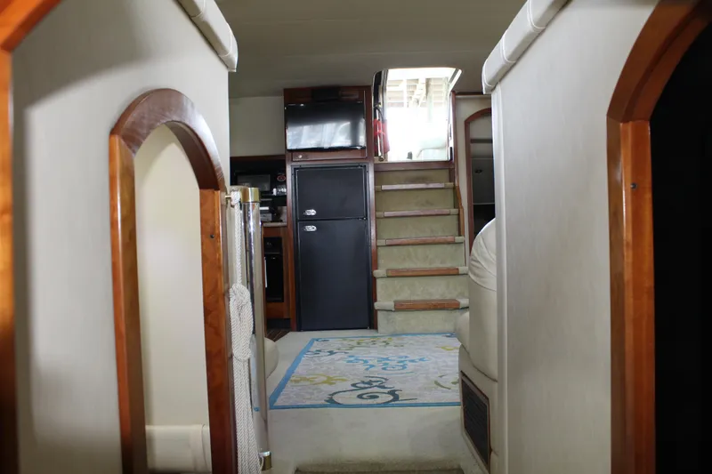 Slide: The Image of Interior of 2005 Cruisers 455 Express Motor Yacht with stairs and cozy living space. - 21