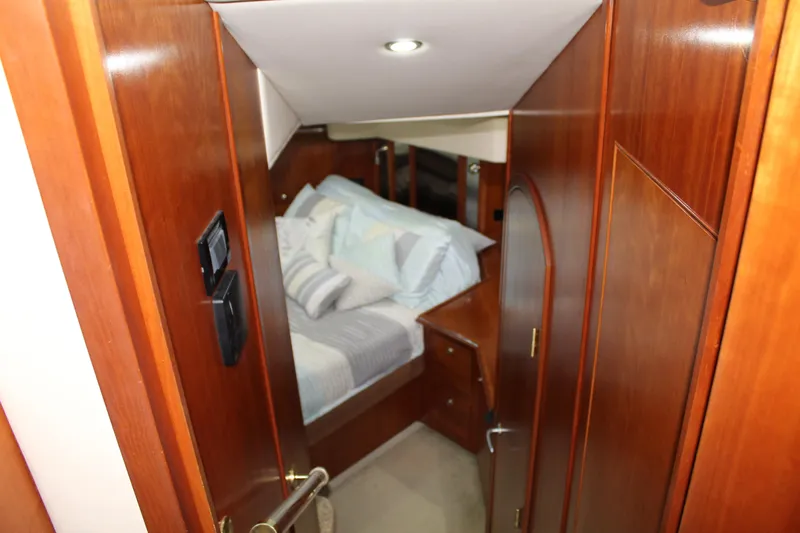 Slide: The Image of Luxurious cabin interior of 2005 Cruisers 455 Express Motor Yacht with wood paneling. - 22