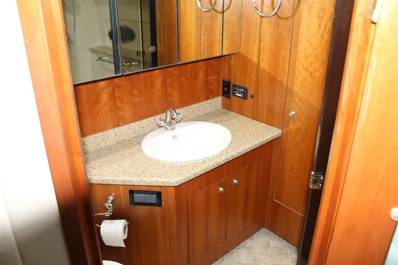 Slide: The Image of Luxurious 2005 Cruisers 455 Express Motor Yacht bathroom with wood cabinetry and granite countertop. - 24