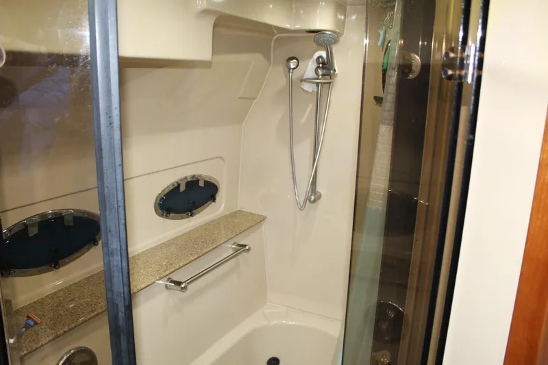 Slide: The Image of 2005 Cruisers 455 Express Motor Yacht shower with glass door and modern fixtures. - 26