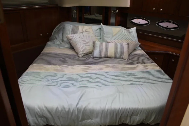 Slide: The Image of Luxurious bedroom interior of 2005 Cruisers 455 Express Motor Yacht with striped bedding. - 27