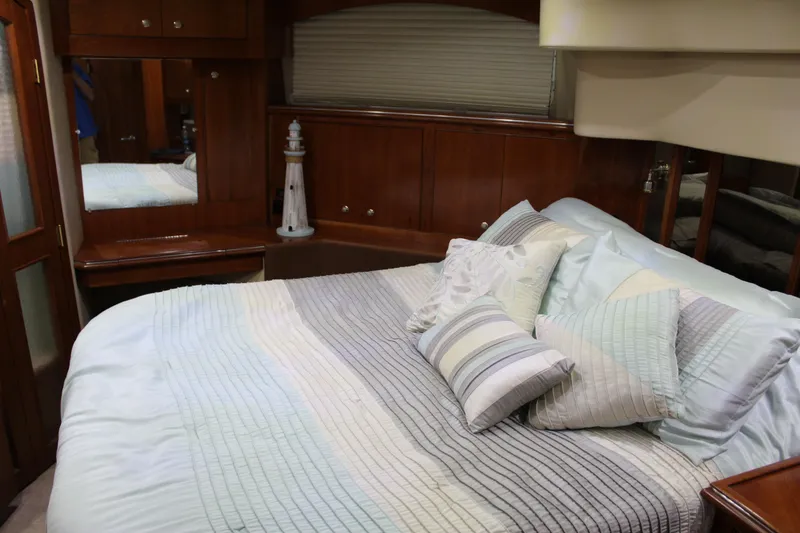 Slide: The Image of Luxurious bedroom interior of 2005 Cruisers 455 Express Motor Yacht with elegant bedding. - 28