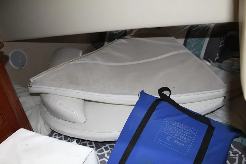 Slide: The Image of Interior cabin of 2005 Cruisers 455 Express Motor Yacht with cushions and blue bag. - 31