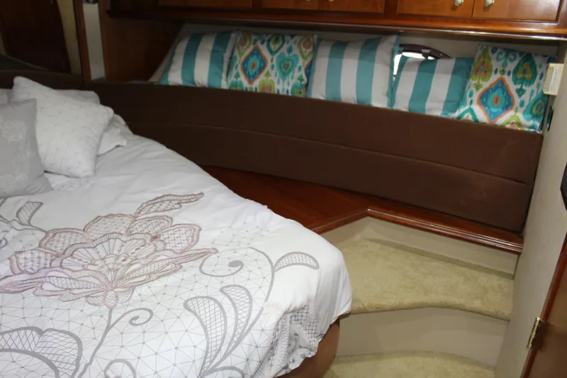Slide: The Image of Luxurious 2005 Cruisers 455 Express Motor Yacht bedroom with elegant bedding and cushions. - 36
