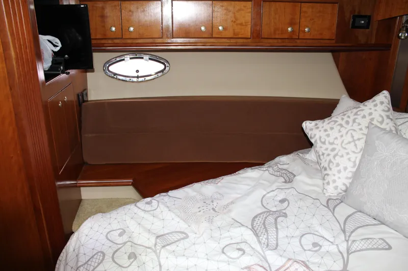 Slide: The Image of Luxurious 2005 Cruisers 455 Express Motor Yacht cabin interior with elegant bedding and wood cabinetry. - 37