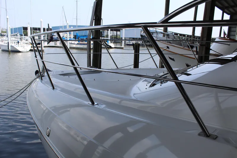 Slide: The Image of 2005 Cruisers 455 Express Motor Yacht docked at marina, sleek design, stainless steel railings. - 5