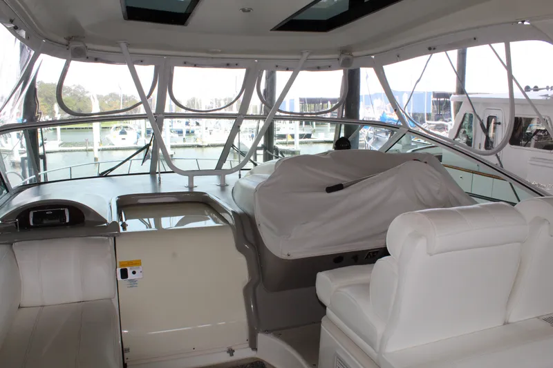 Slide: The Image of 2005 Cruisers 455 Express Motor Yacht interior with covered helm and seating area. - 8