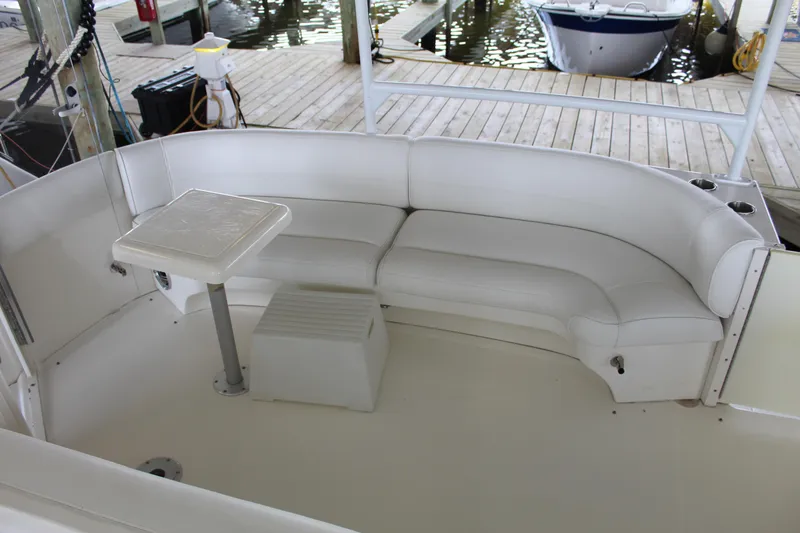 Slide: The Image of 2005 Cruisers 455 Express Motor Yacht with white seating and table on deck. - 9