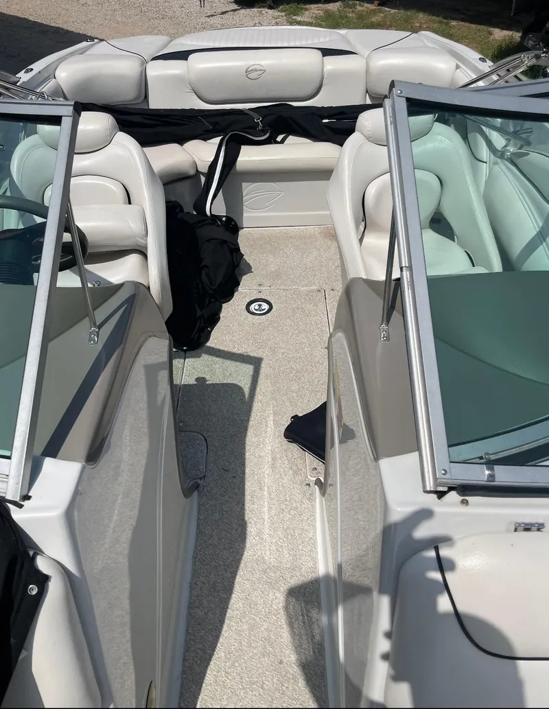 Slide: The Image of 2005 Crownline Runabout boat interior with white seating and open deck layout. - 4