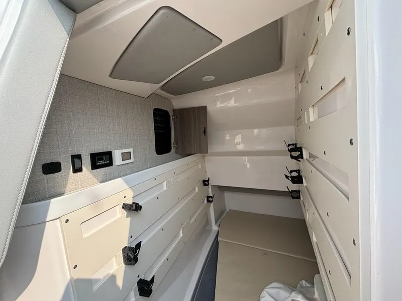 Slide: The Image of 2022 Regal LX36 boat interior cabin with modern design and storage features. - 12