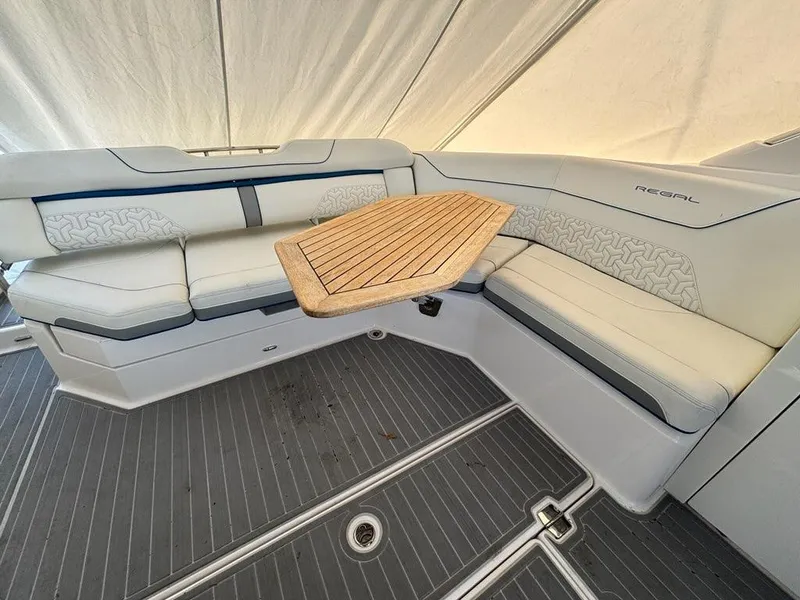 Slide: The Image of Luxurious 2022 Regal LX36 boat interior with elegant seating and wooden table. - 15