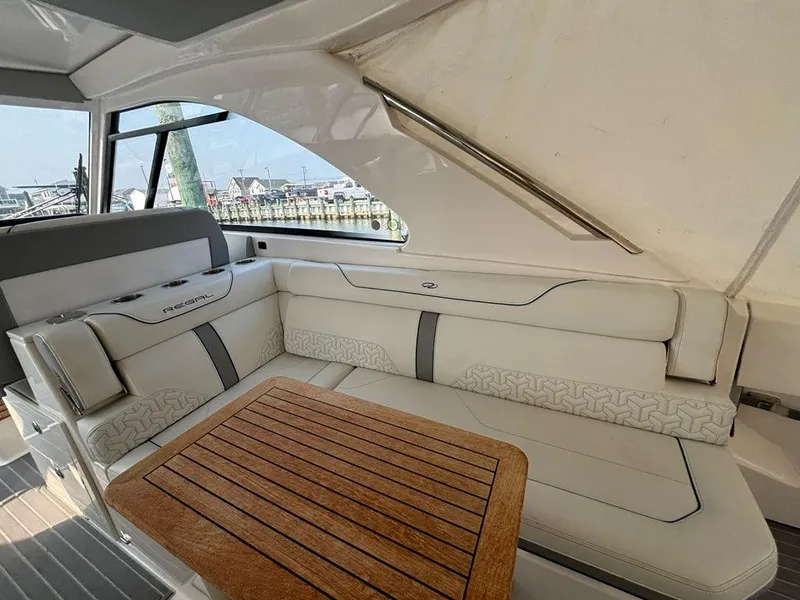 Slide: The Image of Luxurious interior of 2022 Regal LX36 yacht with elegant seating and wooden table. - 16