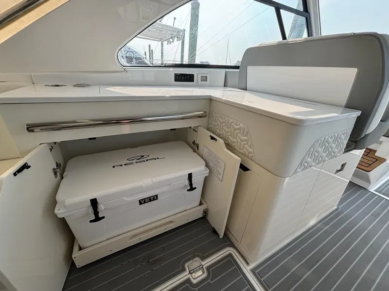Slide: The Image of 2022 Regal LX36 boat interior with Yeti cooler storage compartment. - 17