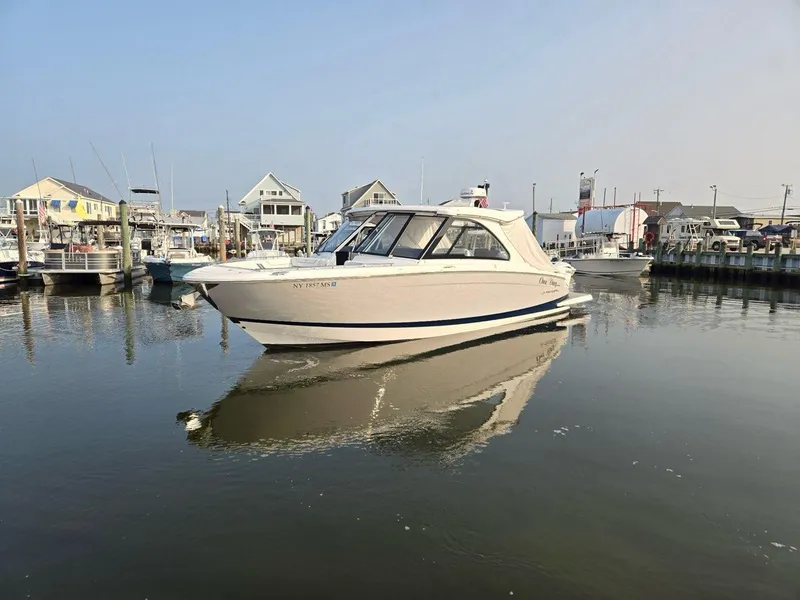 Slide: The Image of 2022 Regal LX36 boat docked in a serene marina setting. - 3