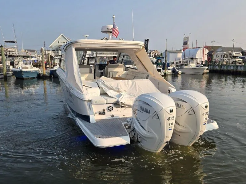 Slide: The Image of 2022 Regal LX36 boat with twin Yamaha engines docked in a marina. - 7