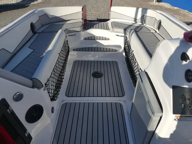 Slide: The Image of 2023 Caravelle Powerboats 251 XL with Suzuki outboard motor, docked under a sunny sky. - 10