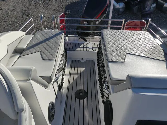 Slide: The Image of 2023 Caravelle Powerboats 251 XL interior storage compartment with cushioned seating. - 16