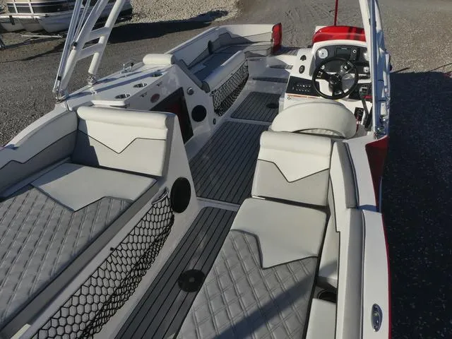 Slide: The Image of 2023 Caravelle Powerboats 251 XL with Suzuki outboard motor, parked on a trailer. - 9