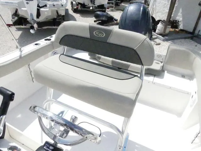 Slide: The Image of 2025 Key West 203 FS boat interior with steering wheel and seating. - 10
