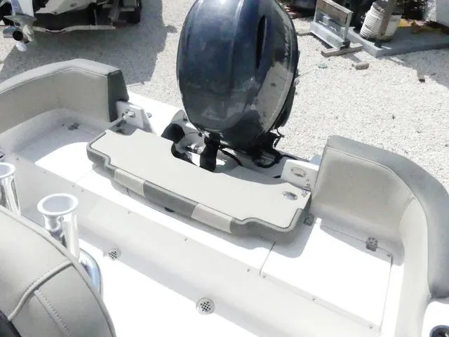Slide: The Image of 2025 Key West 203 FS boat with outboard motor and seating area. - 11
