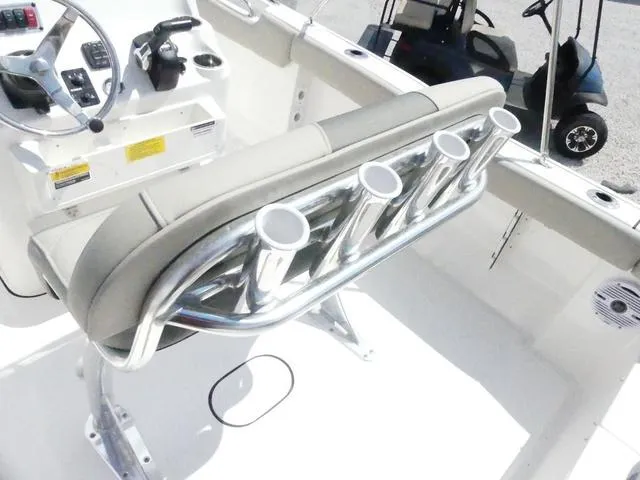 Slide: The Image of 2025 Key West 203 FS boat interior with rod holders and steering console. - 12