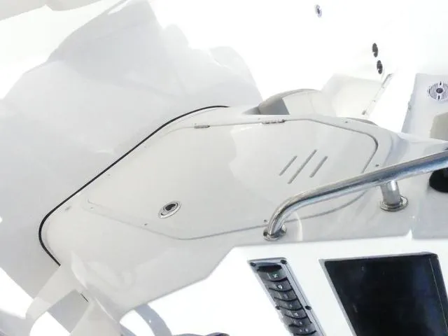 Slide: The Image of 2025 Key West 203 FS boat interior with sleek white design and control panel. - 13