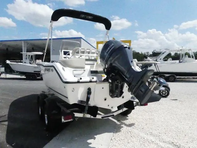 Slide: The Image of 2025 Key West 203 FS boat with outboard motor on trailer, sunny day. - 4