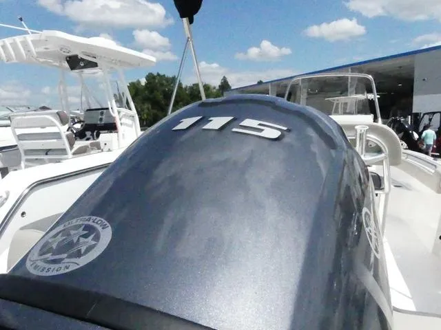 Slide: The Image of 2025 Key West 203 FS boat with 115 horsepower engine, docked under blue sky. - 6