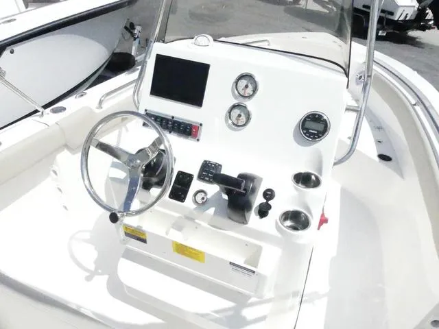 Slide: The Image of 2025 Key West 203 FS boat console with steering wheel and gauges. - 7