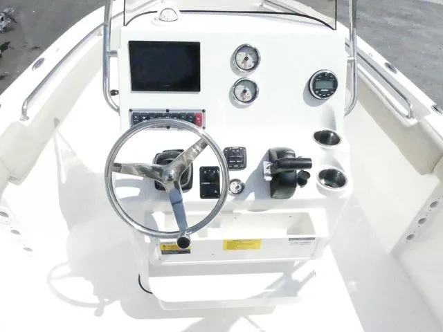 Slide: The Image of 2025 Key West 203 FS boat console with steering wheel and gauges. - 8