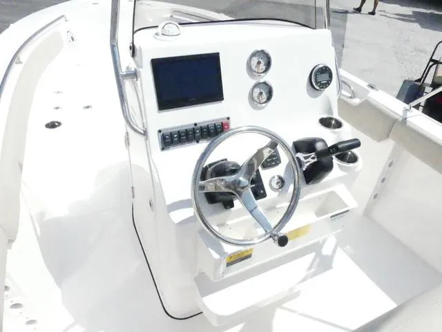 Slide: The Image of 2025 Key West 203 FS boat console with steering wheel and gauges. - 9