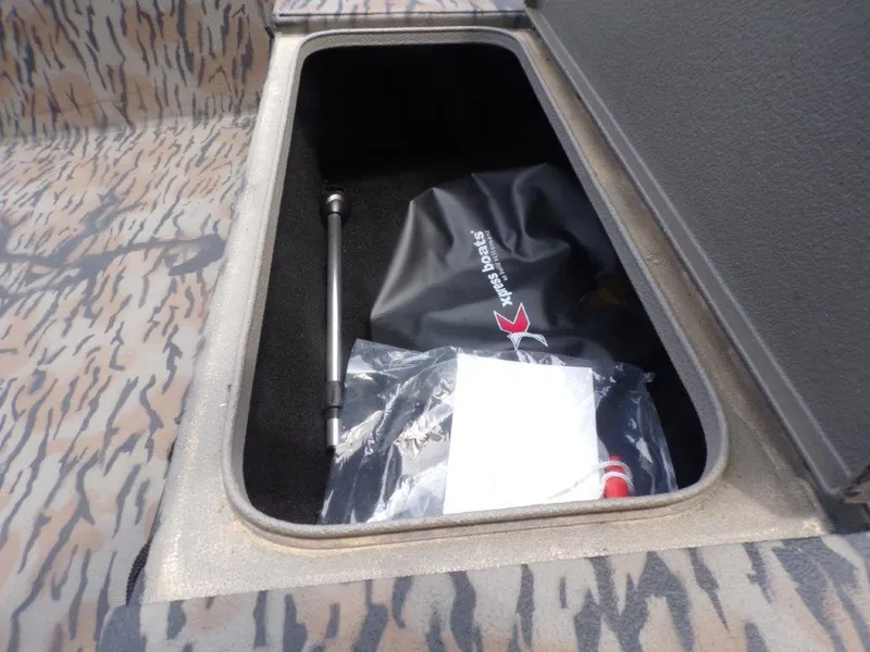 Slide: The Image of 2024 Xpress HD15DBX storage compartment with accessories and camouflage interior. - 6