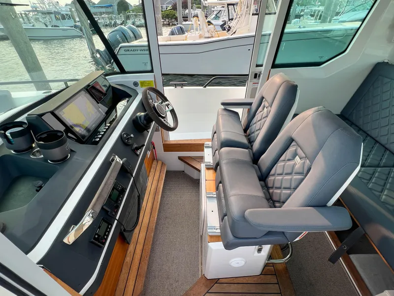Slide: The Image of Interior of 2020 Axopar 28 CABIN with modern helm and comfortable seating. - 10