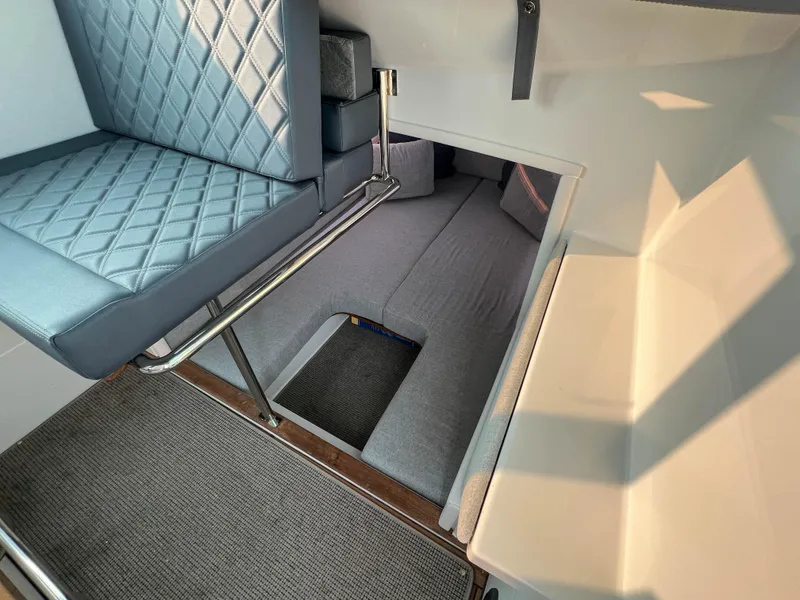 Slide: The Image of Interior of 2020 Axopar 28 CABIN with seating and sleeping area. - 17
