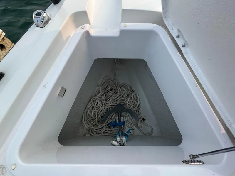 Slide: The Image of Anchor storage compartment on 2020 Axopar 28 CABIN boat with coiled rope. - 21