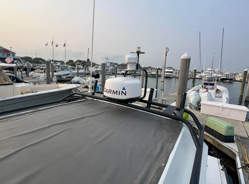 Slide: The Image of 2020 Axopar 28 CABIN boat docked with Garmin equipment, marina background. - 23