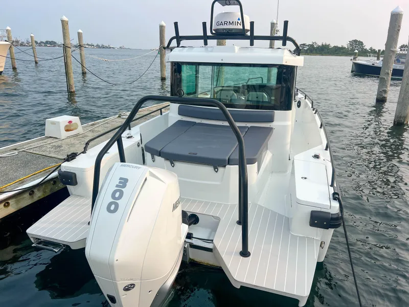 Slide: The Image of 2020 Axopar 28 CABIN boat with 300 HP engine docked at marina. - 3