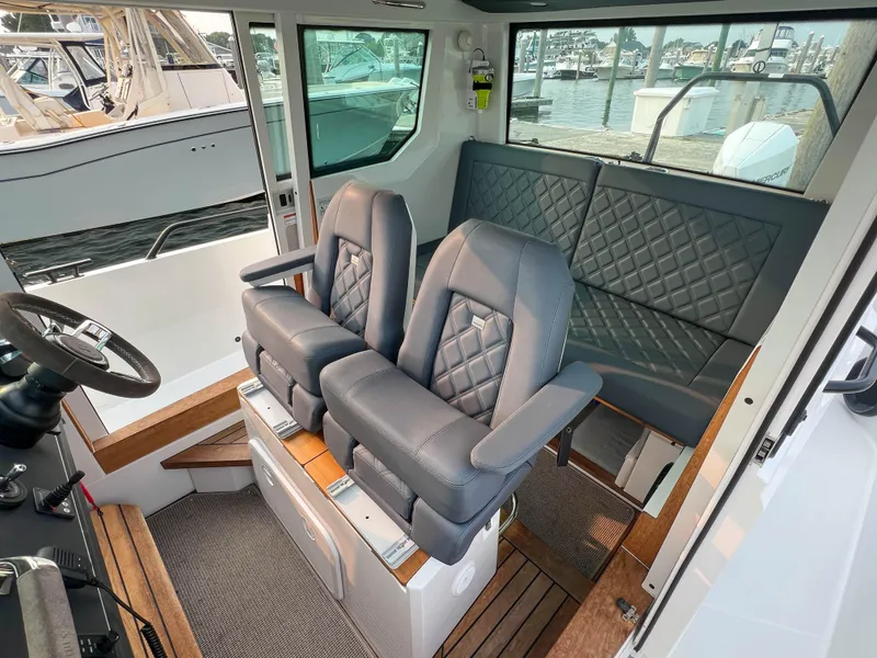 Slide: The Image of 2020 Axopar 28 CABIN interior with plush seating and modern design. - 9