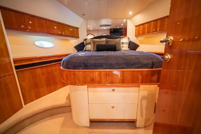 Slide: The Image of Luxurious 2005 Neptunus 62 Flybridge yacht bedroom with elegant wood finish and cozy bedding. - 10