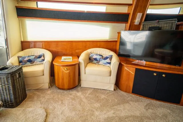 Slide: The Image of Luxurious Neptunus 62 Flybridge 2005 interior with cozy seating and modern TV setup. - 11