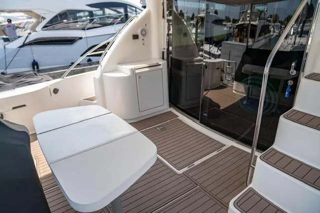 Slide: The Image of 2005 Neptunus 62 Flybridge yacht deck with seating and stairs. - 15
