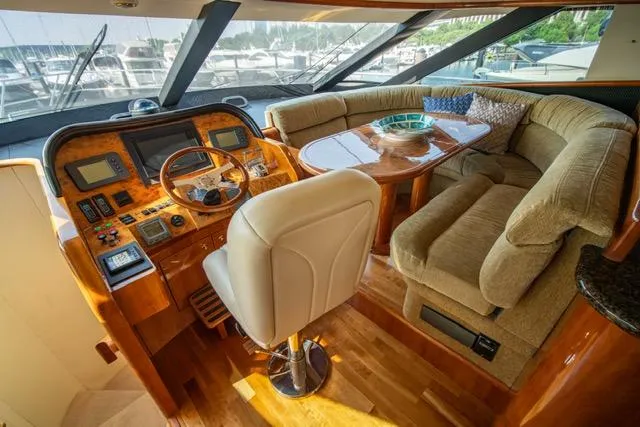 Slide: The Image of Luxurious 2005 Neptunus 62 Flybridge yacht interior with plush seating and modern helm. - 16