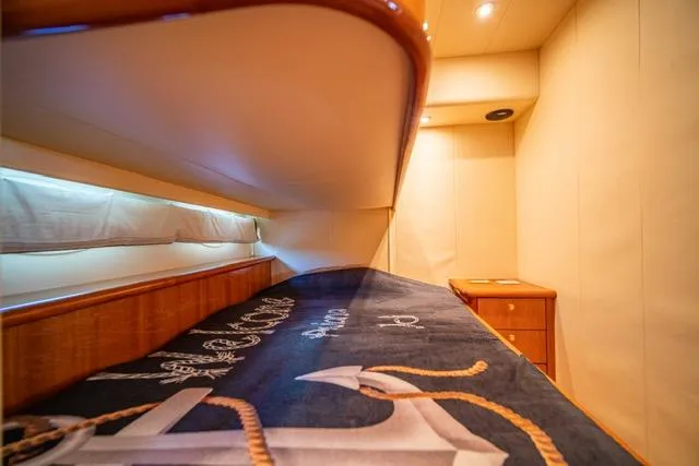Slide: The Image of Luxurious 2005 Neptunus 62 Flybridge yacht cabin with nautical-themed bedding. - 17