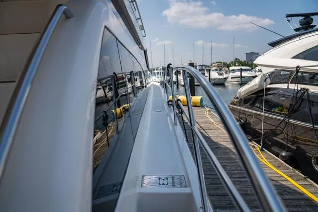 Slide: The Image of Side view of 2005 Neptunus 62 Flybridge yacht docked at marina. - 18