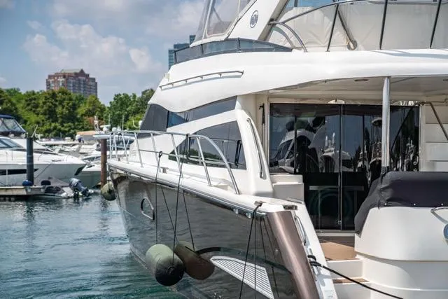Slide: The Image of 2005 Neptunus 62 Flybridge yacht docked in marina, sunny day. - 21