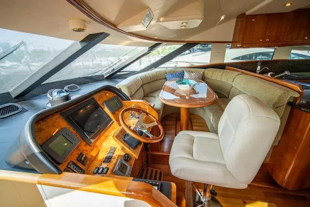 Slide: The Image of Luxurious 2005 Neptunus 62 Flybridge yacht interior with helm and plush seating area. - 22