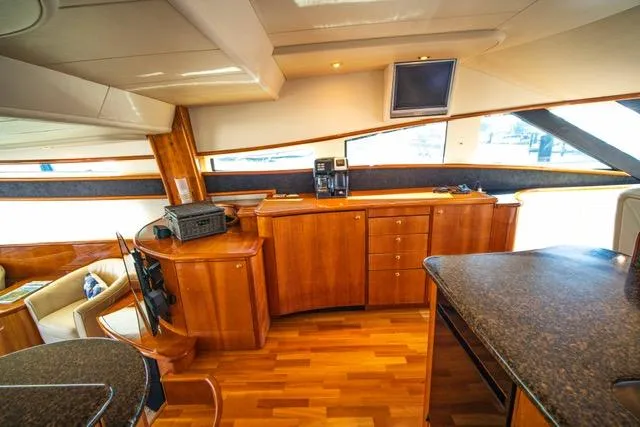 Slide: The Image of Luxurious interior of 2005 Neptunus 62 Flybridge yacht with wood cabinetry and modern amenities. - 23