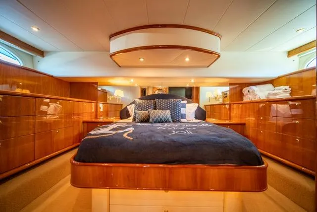 Slide: The Image of Luxurious 2005 Neptunus 62 Flybridge yacht bedroom with elegant wood finishes and plush bedding. - 26