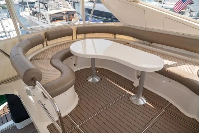 Slide: The Image of Luxurious 2005 Neptunus 62 Flybridge yacht with elegant seating and sleek table design. - 27
