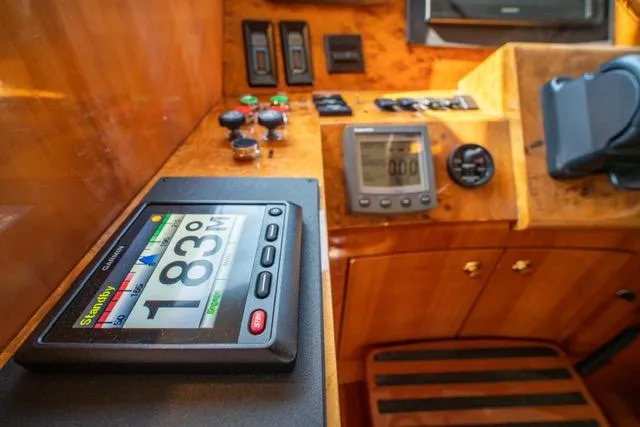 Slide: The Image of Neptunus 62 Flybridge 2005 yacht dashboard with navigation instruments and controls. - 28